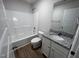 Clean bathroom with a bathtub, toilet and granite vanity at 32 Oakfield Trace Dr, Four Oaks, NC 27524