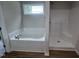 Bathroom featuring a soaking tub and walk-in shower at 32 Oakfield Trace Dr, Four Oaks, NC 27524