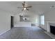 Open living room with vaulted ceiling, fireplace, and kitchen views at 32 Oakfield Trace Dr, Four Oaks, NC 27524