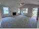 Bright and airy living room with a fireplace and access to the kitchen at 32 Oakfield Trace Dr, Four Oaks, NC 27524