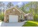 Stone house exterior with a white garage door and landscaping at 490 Shawnee Dr, Louisburg, NC 27549