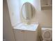 Bathroom with vanity, toilet and oval mirror at 1318 Timothy Avenue Ave, Durham, NC 27707