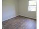 Spacious bedroom with hardwood floors and a large window at 1318 Timothy Avenue Ave, Durham, NC 27707