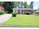 Brick ranch house with a well-manicured lawn at 1318 Timothy Avenue Ave, Durham, NC 27707