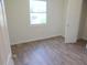 Well-lit bedroom with hardwood floors and a window with street view at 1318 Timothy Avenue Ave, Durham, NC 27707