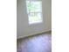 Simple bedroom with wood-look floors and a window at 1318 Timothy Avenue Ave, Durham, NC 27707