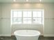 Bathroom with free-standing bathtub and large window at 1140 Cottonsprings Dr, Wendell, NC 27591