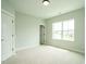 Bright bedroom with plush carpeting, large window, and ample closet space at 1140 Cottonsprings Dr, Wendell, NC 27591