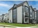 Side view of a contemporary townhome showcasing its gray siding and landscaping at 1140 Cottonsprings Dr, Wendell, NC 27591