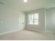 Bright bedroom with carpet flooring, a large window, and a double door closet at 1140 Cottonsprings Dr, Wendell, NC 27591