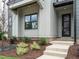 Inviting front entrance with gray siding, brick steps, and black front door at 1140 Cottonsprings Dr, Wendell, NC 27591