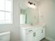 Modern bathroom with white vanity, quartz countertop, and a large mirror at 1140 Cottonsprings Dr, Wendell, NC 27591