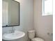Small bathroom with pedestal sink, toilet and framed mirror at 1140 Cottonsprings Dr, Wendell, NC 27591