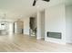 Open living area with hardwood floors, a fireplace, and a staircase at 1140 Cottonsprings Dr, Wendell, NC 27591