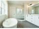 Elegant bathroom with soaking tub, double vanity, and glass shower at 1140 Cottonsprings Dr, Wendell, NC 27591