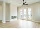 Living room with hardwood floors, fireplace and doors leading to balcony at 1140 Cottonsprings Dr, Wendell, NC 27591