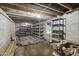 Unfinished basement with shelving units and exposed dirt floor at 2430 Langdon Rd, Angier, NC 27501