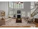 Living room with hardwood floors, fireplace and large windows, staged with furniture at 441 Mountain Laurel, Chapel Hill, NC 27517