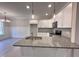 Modern kitchen with white cabinets, granite countertops, and stainless steel appliances at 153 Wilderness Trl, Smithfield, NC 27577