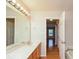 Double vanity bathroom with a large mirror and tub at 216 Stoney Dr, Durham, NC 27703
