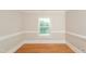 Bright bedroom with hardwood floors and window with blinds at 216 Stoney Dr, Durham, NC 27703
