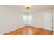 Hardwood floor bedroom with two windows and a closet at 216 Stoney Dr, Durham, NC 27703