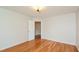 Well-lit bedroom with hardwood floors and access to a hallway at 216 Stoney Dr, Durham, NC 27703