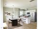 Modern kitchen with white cabinets, granite island, and dining area at 36 Fetterbush Way, Clayton, NC 27520