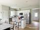 Modern kitchen with white cabinets, granite island, and stainless steel appliances at 36 Fetterbush Way, Clayton, NC 27520