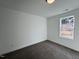 Well-lit bedroom featuring neutral carpeting and a large window at 50 Fetterbush Way, Clayton, NC 27520