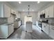 Modern kitchen featuring white cabinets, granite countertops, and stainless steel appliances at 50 Fetterbush Way, Clayton, NC 27520