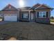 New construction home features gray siding, stone accents, and a two-car garage at 639 Sweet Potato Lane # 3, Nashville, NC 27856