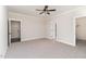 Spacious bedroom with carpet, ceiling fan, and access to bathroom and closet at 609 Tuscany Cir, Princeton, NC 27569