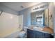 Clean bathroom with a tub, vanity, and dark brown cabinets at 128 Dove Cottage Ln, Cary, NC 27519