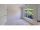 Well-lit bedroom featuring carpet flooring and a large window at 128 Dove Cottage Ln, Cary, NC 27519
