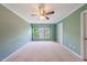 Spacious bedroom with a ceiling fan and large windows at 128 Dove Cottage Ln, Cary, NC 27519
