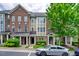 Brick townhome with 3 levels, front porch, and landscaping at 128 Dove Cottage Ln, Cary, NC 27519
