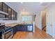 Open concept kitchen with island and stainless steel appliances at 128 Dove Cottage Ln, Cary, NC 27519