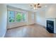 Bright living room with hardwood floors, fireplace, and large windows at 128 Dove Cottage Ln, Cary, NC 27519