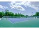 Two tennis courts with surrounding fencing at 128 Dove Cottage Ln, Cary, NC 27519