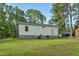 White house exterior with grey bottom and landscaping at 113 Winnebago Loop, Louisburg, NC 27549