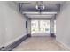 Spacious garage interior with an open overhead door and neutral walls at 508 East End Ave, Durham, NC 27703