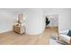 Light-filled hallway with wood floors, stylish console table, and comfortable seating area at 3300 Founding Place, Raleigh, NC 27612