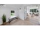 Light hallway with a bench and view into a living area at 3300 Founding Place, Raleigh, NC 27612