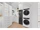 Bright laundry room with washer, dryer, and ample cabinet storage at 3300 Founding Place, Raleigh, NC 27612