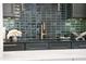 Modern kitchen features dark green cabinets and gold accents at 3300 Founding Place, Raleigh, NC 27612