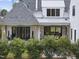 Covered patio with seating area and landscaping, attached to the house at 3300 Founding Place, Raleigh, NC 27612
