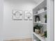 Stylish white shelving unit with decorative objects and plants at 3300 Founding Place, Raleigh, NC 27612