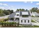 Two-story house, rear view, showcasing patio, landscaping, and neighborhood at 3300 Founding Place, Raleigh, NC 27612