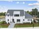 Stunning two-story home with white exterior and gray roof at 3300 Founding Place, Raleigh, NC 27612
